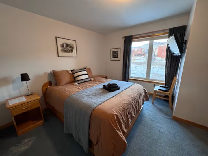 Charming view of the quiet neighborhood and local Iqaluit life just outside your window from this cozy bedroom in room 3 with queen size bed and private en-suite washroom