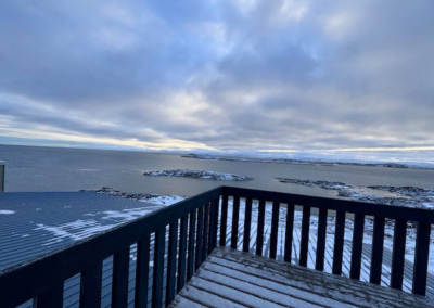 View of Frobisher Bay from the private balcony of Bedroom 1 at Stay by the Sea B&B in Iqaluit, Nunavut, overlooking the ocean and Arctic horizon.