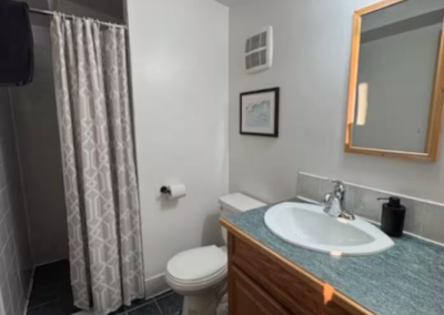 Private ensuite bathroom in Bedroom 6 at Stay by the Sea B&B in Iqaluit, Nunavut, with a modern walk-in shower, vanity, and guest-ready amenities.
